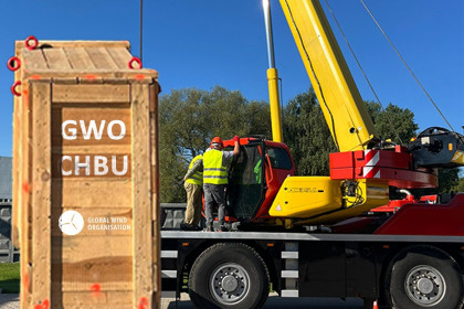 Crane, two operators and a box for lifting